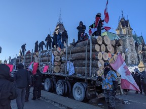 Freedom Convoy 2022 Live Updates: Thousands Pack Parliament Hill For Protest 3 Demonstrators climb a loaded logging truck on the street in front of the National War Memorial, Saturday, January 29, 2021.