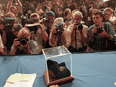 Photographers take pictures of the ALH84001 meteorite at a press conference on August 7, 1996, where scientists from NASA and Stanford University said they have detected traces of bacterial life on MARS after studying the meteorite discovered on December 27, 1984 in the Allan Hills region of Antarctica.