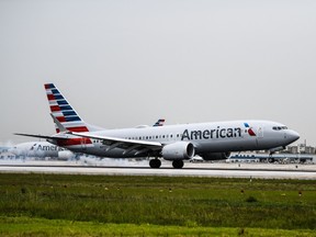 An American Airlines plane lands at the Miami International Airport in July 2021. A pilot decided to turn around an hour after takeoff on flight from Miami to London on Wednesday, after a woman refused to wear a mask on the plane.