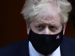 British Prime Minister Boris Johnson walks outside Downing Street in London, Britain, January 12, 2022
