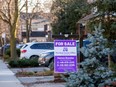 A for sale sign is displayed outside a home in Toronto, on Dec. 13, 2021.