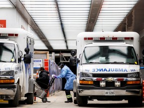 An ambulance crew member delivers a patient at Toronto's Mount Sinai Hospital on Jan. 3, 2022.