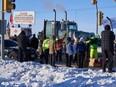 Supporters on the Trans-Canada Highway west of Winnipeg cheer on truckers in the Freedom Convoy headed to Ottawa to protest the federal COVID-19 vaccine mandate for truck drivers, on Jan. 25, 2022.