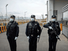 Police stand outside a detention center in Dabancheng in western China's Xinjiang Uyghur Autonomous Region. A human rights group estimates that the number of forced repatriations by China has increased rapidly during the COVID-19 pandemic.