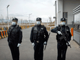 Police stand outside a detention center in Dabancheng in western China's Xinjiang Uyghur Autonomous Region. A human rights group estimates that the number of forced repatriations by China has increased rapidly during the COVID-19 pandemic.