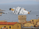 View of the wrecked cruise liner Costa Concordia on January 16, 2012,  in the harbour of the Tuscan island of Giglio after it ran aground after hitting underwater rocks on January 13.