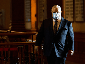 Ontario Premier Doug Ford walks to a press conference at Queen’s Park regarding the easing of restrictions during the COVID-19 pandemic in Toronto on January 20, 2022.