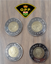 According to the Ontario Provincial Police, someone is apparently trying to spend these fake toonies around Hawkesbury, Ont, a community along the Ontario-Quebec border. While trying to pass these off as legal tender is illegal, their design is so unusual it’s not clear whether they would qualify as counterfeit currency, per se. The coin’s denomination is “Z DOLLARD,” the obverse features a walrus instead of a polar bear, and the reverse seems to show Neville Chamberlain instead of Queen Elizabeth II.