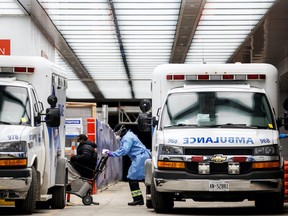 An ambulance crew delivers a patient at Mount Sinai Hospital as officials warned of a "tsunami" of new coronavirus disease (COVID-19) cases in the days and weeks ahead due to the Omicron variant in Toronto, Ontario, Canada January 3, 2022. REUTERS/Cole Burston.