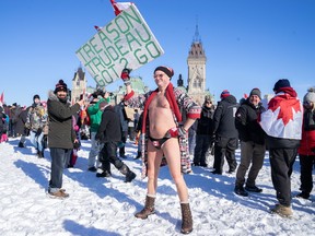 Protestors gather in front of Parliament Hill as truckers and supporters take part in a convoy to protest coronavirus disease (COVID-19) vaccine mandates for cross-border truck drivers in Ottawa, Ontario, Canada, January 29, 2022.  REUTERS/Michael Chisholm