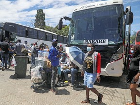 Passengers in Johannesburg, South Africa board buses traveling to Zimbabwe, amid the spread of the SARS-CoV-2 Omicron variant , December 14, 2021.