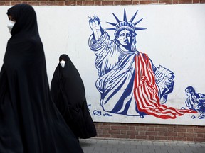 Demonstrators stand in front of the former U.S. Embassy in Tehran, which is plastered with anti-American murals, to mark the 42nd anniversary of the U.S. expulsion from Iran, on Nov. 4, 2021.