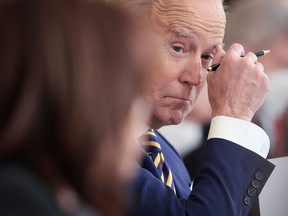 U.S. President Joe Biden listens as Vice-President Kamala Harris speaks during an event at the White House on Jan. 31, 2022, in Washington, D.C. The prospects for the second half of Biden's term "will drop from thin to grim should Democrats lose one or both Houses of Congress in November," writes Derek H. Burney.
