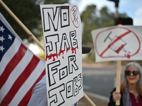Workers at NASA's Jet Propulsion Laboratory (JPL) and their supporters protest outside JPL in Pasadena, California against a U.S. government mandate requiring all federal employees to receive the COVID-19 vaccine. (Photo by ROBYN BECK/AFP via Getty Images)