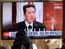 People watch North Korean leader Kim Jong Un on a television at a railway station in Seoul, South Korea, on January 1, 2022.