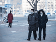 Pedestrians walk on a street in Pyongyang on December 28, 2021. Increasingly, even the wealthiest in North Korea's capital are experiencing shortages of food, medicine, and fuel to heat their homes during the bitter winter.