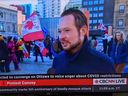 Alberta MP Michael Cooper said he did an impromptu TV interview, and moments later he learned via social media that a person he is not connected to was standing behind his back and holding a flag with a 