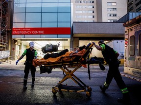 An ambulance crew delivers a patient to Mount Sinai Hospital in downtown Toronto on Jan. 3, 2022. Ontario Premier Doug Ford has warned of a possible "tsunami" of Omicron cases that could overwhelm hospitals in the province.