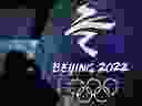 A man photographs an illuminated logo ahead of the 2022 Winter Olympics in Beijing, China, on Jan. 26, 2022.