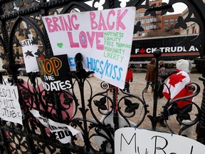 Protest signs are seen attached to the main gate to Parliament Hill, as demonstrations by truckers and their supporters against the coronavirus disease (COVID-19) vaccine mandates continue, in Ottawa, Ontario, Canada, January 31, 2022. REUTERS / Blair Gable