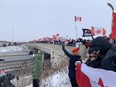 Hundreds of supporters gathered on the Wellington Road overpass Thursday to watch the Convoy for Freedom 2022, part of a nationwide protest against cross-border COVID-19 vaccine mandates. The convoy of transport trucks is on its way to Ottawa for a rally at Parliament Hill. DALE CARRUTHERS/POSTMEDIA NETWORK