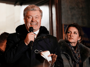 Ukrainian former President Petro Poroshenko, who is accused of high treason by financing pro-Russian separatists in eastern Ukraine while in office in 2014-2015, addresses supporters as his wife Maryna stands nearby, after leaving a court building in Kyiv, Ukraine, January 17, 2022.