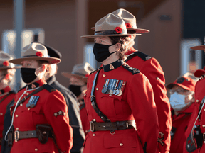 Members of the RCMP stand at attention during a Remembrance Day ceremony in Iqaluit, Nunavut, on November 11, 2021.