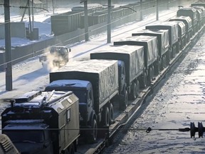 In this photo taken from video, Russian military vehicles on a railway platform on their way to attend a joint military drills in Belarus, in Russia, Monday, Jan. 24, 2022.