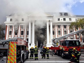 Firefighters work after a fire broke out in the Parliament in Cape Town, South Africa, January 2, 2022