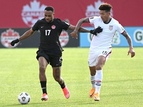 Jan 30, 2022; Hamilton, Ontario, CAN;    Canada forward Cyle Larin (17) dribbles the ball away from United States defender Chris Richards (15) during a CONCACAF FIFA World Cup Qualifier soccer match at Tim Hortons Field