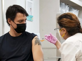 Justin Trudeau, Canada’s prime minister, receives a Covid-19 vaccine booster shot at a pharmacy in Ottawa, Ontario, Canada, on Tuesday, Jan. 4, 2022.  x