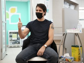 Prime Minister Justin Trudeau gives a thumbs up after receiving a COVID-19 vaccine booster shot at a pharmacy in Ottawa, Ontario, on Tuesday, Jan. 4, 2022. Sean Kilpatrick/Canadian Press/Bloomberg