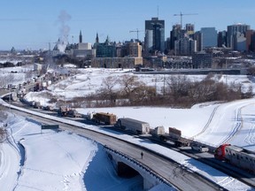 Vehicles joining Freedom Convoy 2022 choke the Sir John A. Macdonald parkway, paralleling the Rideau Canal and leading in to downtown Ottawa, Sunday, Jan. 30, 2022.