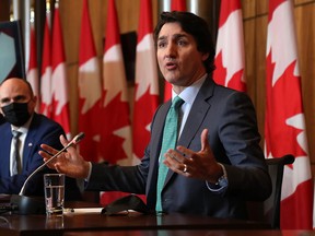 Prime Minister Justin Trudeau is accompanied by Health Minister Jean-Yves Duclos at a press conference in Ottawa on Jan. 5, 2022. A reader says politicians on both the right and the left need to tone down the rhetoric.