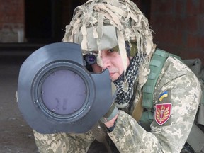 A Ukrainian service member points a next generation light anti-tank weapon (NLAW) supplied by Britain amid tensions between Russia and the West over Ukraine, during drills in the Lviv region of Ukraine in a handout photo released on Jan. 27, 2022.