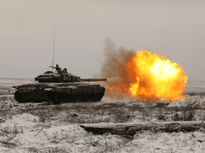 A Russian tank T-72B3 fires as troops take part in drills at the Kadamovskiy firing range in the Rostov region in southern Russia, Jan. 12, 2022.
