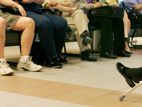Patients sit in a full emergency room waiting room at the Royal Victoria Hospital in Montreal.