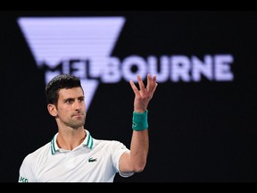 Serbia's Novak Djokovic reacts after a point against Russia's Daniil Medvedev during their men's singles final match on day 14 of the Australian Open tennis tournament in Melbourne, on Feb. 21, 2021.