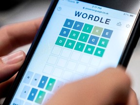 This photo illustration shows a person playing online word game "Wordle" on a mobile phone in Washington, DC on January 11, 2022.