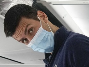 Novak Djokovic prepares to take his seat on a plane to Belgrade, in Dubai, United Arab Emirates on Monday, Jan. 17, 2022.