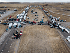 Anti-vaccine mandate protesters gather as a truck convoy blocks the highway the busy U.S. border crossing in Coutts, Alberta., Jan. 31, 2022.