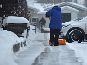 Snow is cleared from sidewalk in southwest Edmonton on January 7, 2022. Ed Kaiser/Postmedia