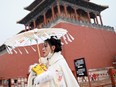 A woman wearing a traditional "hanfu" visits the Forbidden City in Beijing on January 20, 2022. If you believe polls released by Chinese Communist Party propaganda organs, she's disproportionately likely to not to not have particularly warm feelings towards Canada.