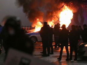 A view shows a burning police car during a protest against LPG cost rise following the Kazakh authorities' decision to lift price caps on liquefied petroleum gas in Almaty, Kazakhstan on Jan. 5, 2022