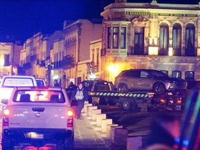Police forces work on site while removing a vehicle with corpses left by unknown assaults in front of the government palace in Zacatecas, Mexico on January 6.