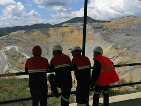 Workers look at Veliki Krivelj open pit copper mine, operated by China’s jin Mining Group Co., in Serbia.