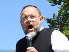 Henry Hildebrandt, the pastor of Aylmer's Church of God, was one of the speakers Sunday at an anti-lockdown rally in Woodstock's Museum Square.