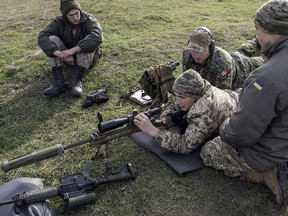 A Canadian soldier coaches Ukrainians on how to operate Canadian small arms at the International Peacekeeping and Security Centre in Ukraine in this file photo from 2015.