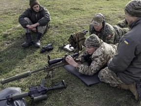 A Canadian soldier trains Ukrainian troops on how to operate Canadian small arms at the International Peacekeeping and Security Centre in Ukraine in 2015.