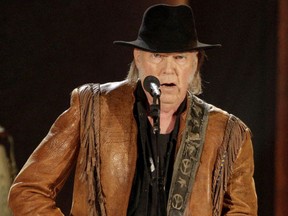Neil Young performs during a concert honouring Willie Nelson, recipient of the Library of Congress' Gershwin Prize for Popular Song, in Washington on Nov. 18, 2015. Young has pulled his music library from Spotify to protest Joe Rogan's podcasts.